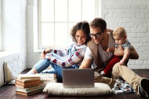 Image of a young family on their laptop