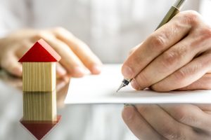 picture of a man signing a contract on a new build